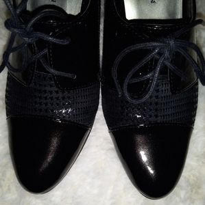 Adorable, fun pair of black heels with tie front. Similar to "wing tip" style.